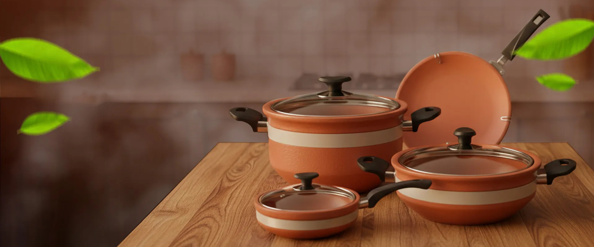 Set of ceramic cookware with lids on a wooden surface, surrounded by green leaves.