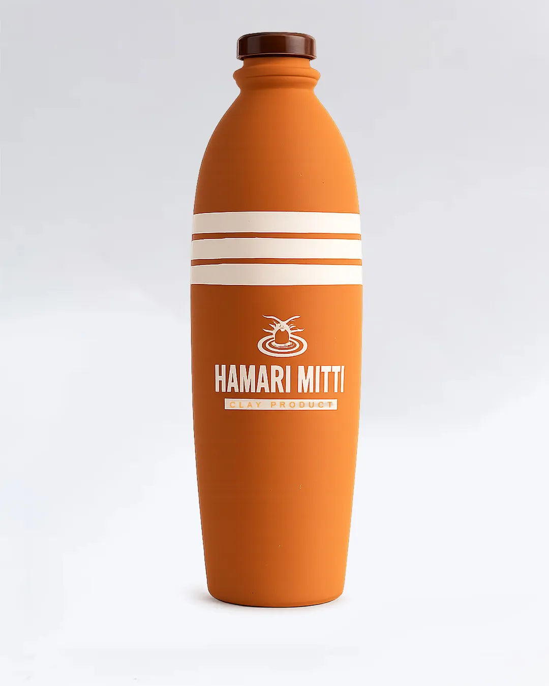 Orange bottle with white stripes and 'HAMARI MITTI' branding on a light gray background